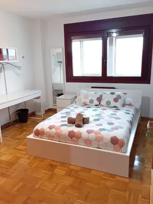 a bedroom with a bed with a teddy bear on it at Lusquefusque in Monforte de Lemos