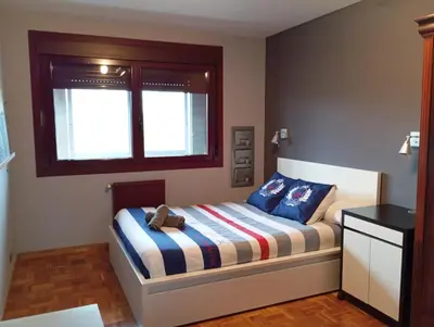 a bedroom with a bed with a teddy bear on it at Lusquefusque in Monforte de Lemos