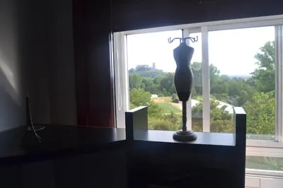 a vase sitting on a table in front of a window at Lusquefusque in Monforte de Lemos
