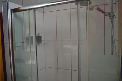 a shower with a glass door in a bathroom at Lusquefusque in Monforte de Lemos