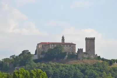 an old castle on top of a hill with trees at Lusquefusque in Monforte de Lemos