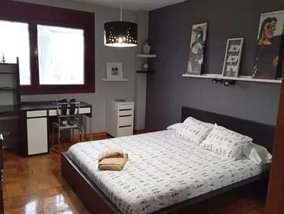 a bedroom with a bed and a desk in it at Lusquefusque in Monforte de Lemos