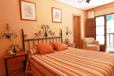 a bedroom with a large bed with orange pillows at Tixileiro in Sisterna