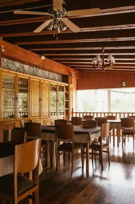 a dining room with wooden tables and chairs at Tixileiro in Sisterna