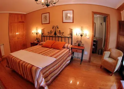 a bedroom with a bed and a chair at Tixileiro in Sisterna