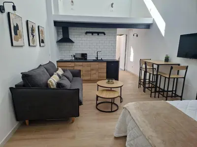 a living room with a couch and a table at Apartamentos Pasiño in Portomarin