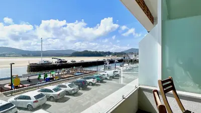 a balcony with cars parked next to a marina at The Cliffs A Ribeira - Pampillosa in Foz