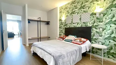 a bedroom with a bed and a green wall at The Cliffs A Ribeira - Rapadoira in Foz
