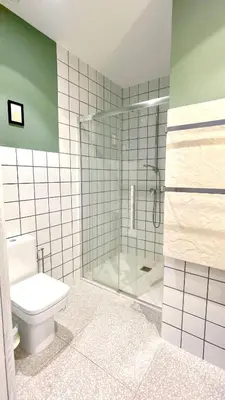 a bathroom with a toilet and a glass shower at The Cliffs A Ribeira - Rapadoira in Foz
