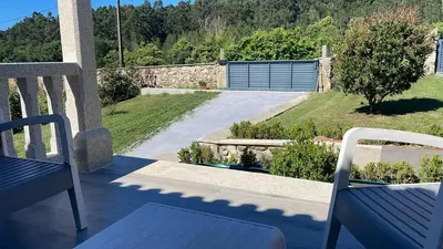 a view from the balcony of a house with two chairs at Casa vanguardista en el campo cerca de Santiago in Pontevedra
