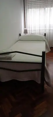 a large bed in a bedroom with a window at Pensión La Plaza in Betanzos