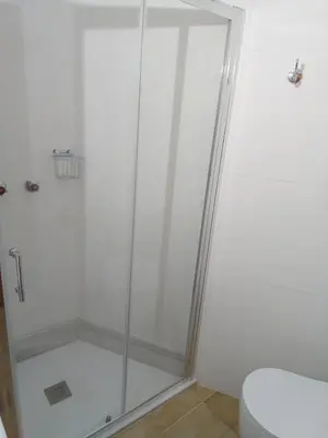 a shower stall in a bathroom with a toilet at Pensión La Plaza in Betanzos