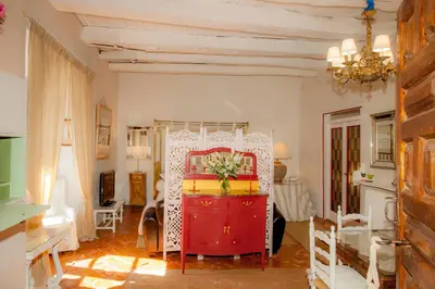 a living room with a red dresser in a room at Arzipreste I Casa del Cura in León