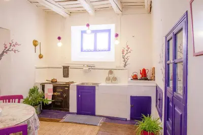 a kitchen with purple cabinets and a window at Arzipreste I Casa del Cura in León