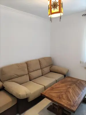a living room with a couch and a coffee table at Casa la Camila in Tapia de Casariego