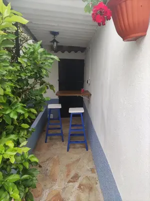 two blue stools sitting in a room with a table at Casa la Camila in Tapia de Casariego