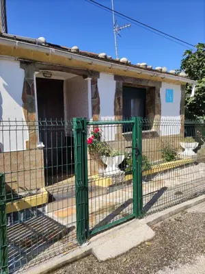 a green fence in front of a house at Casa la Camila in Tapia de Casariego