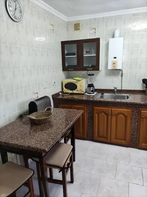a kitchen with a sink and a table with chairs at Casa la Camila in Tapia de Casariego