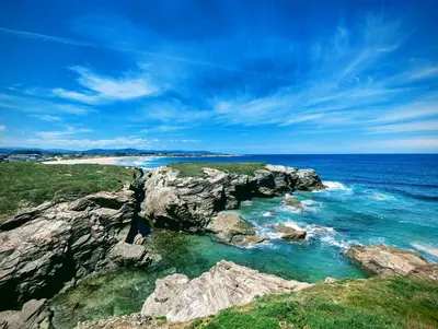 an aerial view of a beach with rocks and the ocean at Casa Doñano in Ribadeo
