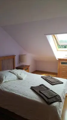 a bedroom with a bed with two towels on it at La Tebaida in Ponferrada