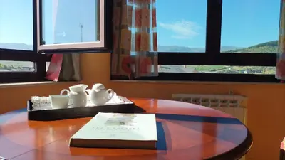a table with a book on top of a table at La Tebaida in Ponferrada