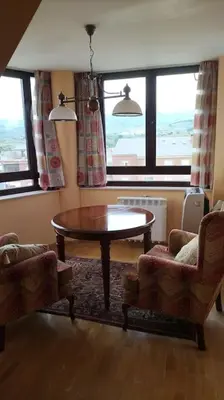 a living room with a table and two chairs at La Tebaida in Ponferrada