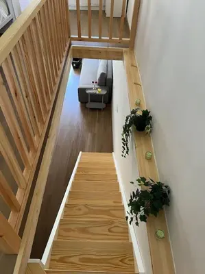 a staircase in a house with two potted plants at A Casiña do Rey Casita junto a la playa de Cabañas in Cabañas
