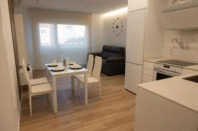 a kitchen and living room with a table and chairs at Rest Pedrouzo in O Pedrouzo