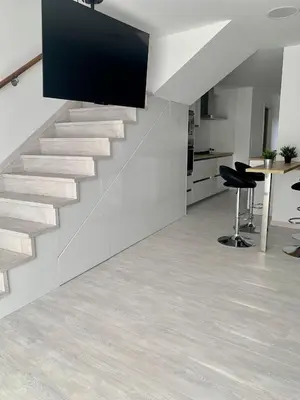 a staircase in a room with a table and chairs at Amencer en Llas in Foz