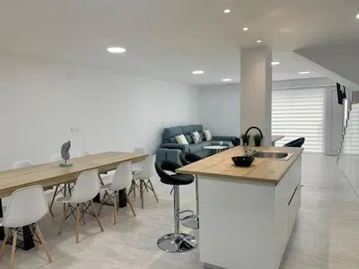 a kitchen and living room with a table and chairs at Amencer en Llas in Foz
