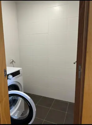 a bathroom with a washing machine in a room at Apartamento Playa las catedrales in Foro