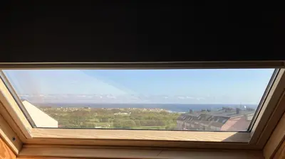 a window with a view of the ocean at Apartamento Playa las catedrales in Foro
