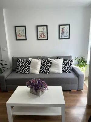 a living room with a couch and a table at Adiva Suite in Puentedeume