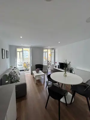 a living room with a couch and a table at Adiva Suite in Puentedeume