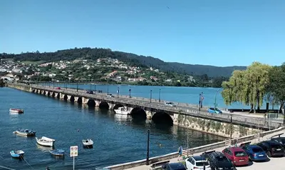 a bridge over a river with cars on it at Adiva Suite in Puentedeume