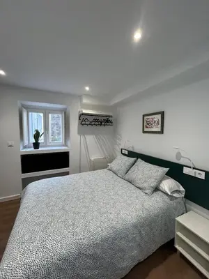 a bedroom with a large bed and a window at Adiva Suite in Puentedeume