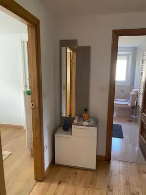 a room with a mirror and a table in it at Casa do Feligrés e da Alsira in Nogueira
