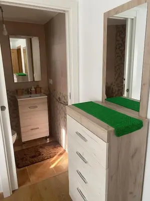 a bathroom with a vanity with a green counter top at Casa do Feligrés e da Alsira in Nogueira