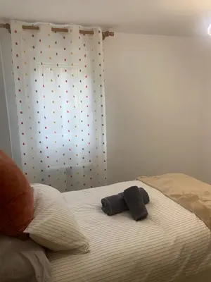 a bed with two towels sitting on top of it at Casa do Feligrés e da Alsira in Nogueira