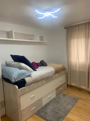 a bedroom with a bed with a light on the ceiling at Casa do Feligrés e da Alsira in Nogueira