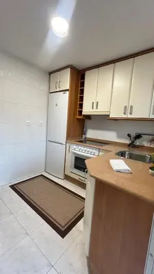 a kitchen with white cabinets and a counter top at Duplex Olas de Ribadeo in Ribadeo