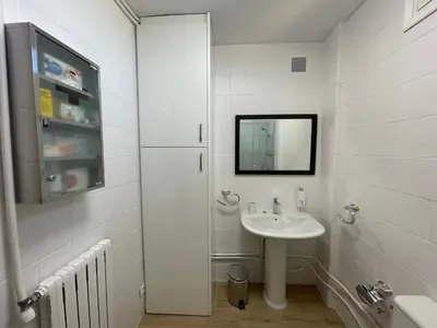 a white bathroom with a sink and a mirror at Los Balcones de Vega in Vega de Espinareda