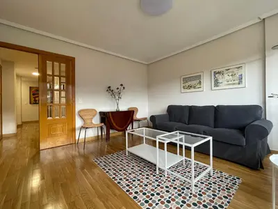 a living room with a couch and a table at Los Balcones de Vega in Vega de Espinareda