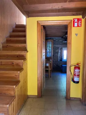 a hallway with yellow walls and stairs in a house at Somiedoeco in Caunedo
