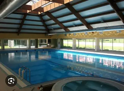 a large indoor swimming pool with a large swimming pool at Somiedoeco in Caunedo