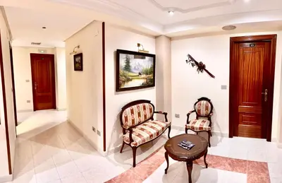 a living room with two chairs and a table at Hostal La Cubana in Carballino