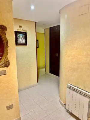 a hallway with a door and a tv on a wall at Hostal La Cubana in Carballino