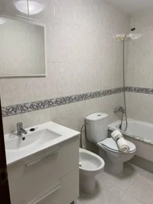 a bathroom with a sink and a toilet and a mirror at o piso de loli e manolo in Santiago de Compostela