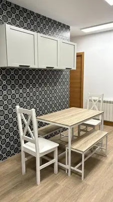 a dining room with a table and white chairs at Apartamentos Torres del Milladoiro in Amés