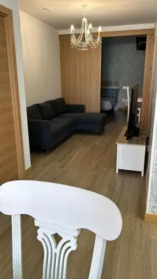 a living room with a couch and a table at Apartamentos Torres del Milladoiro in Amés